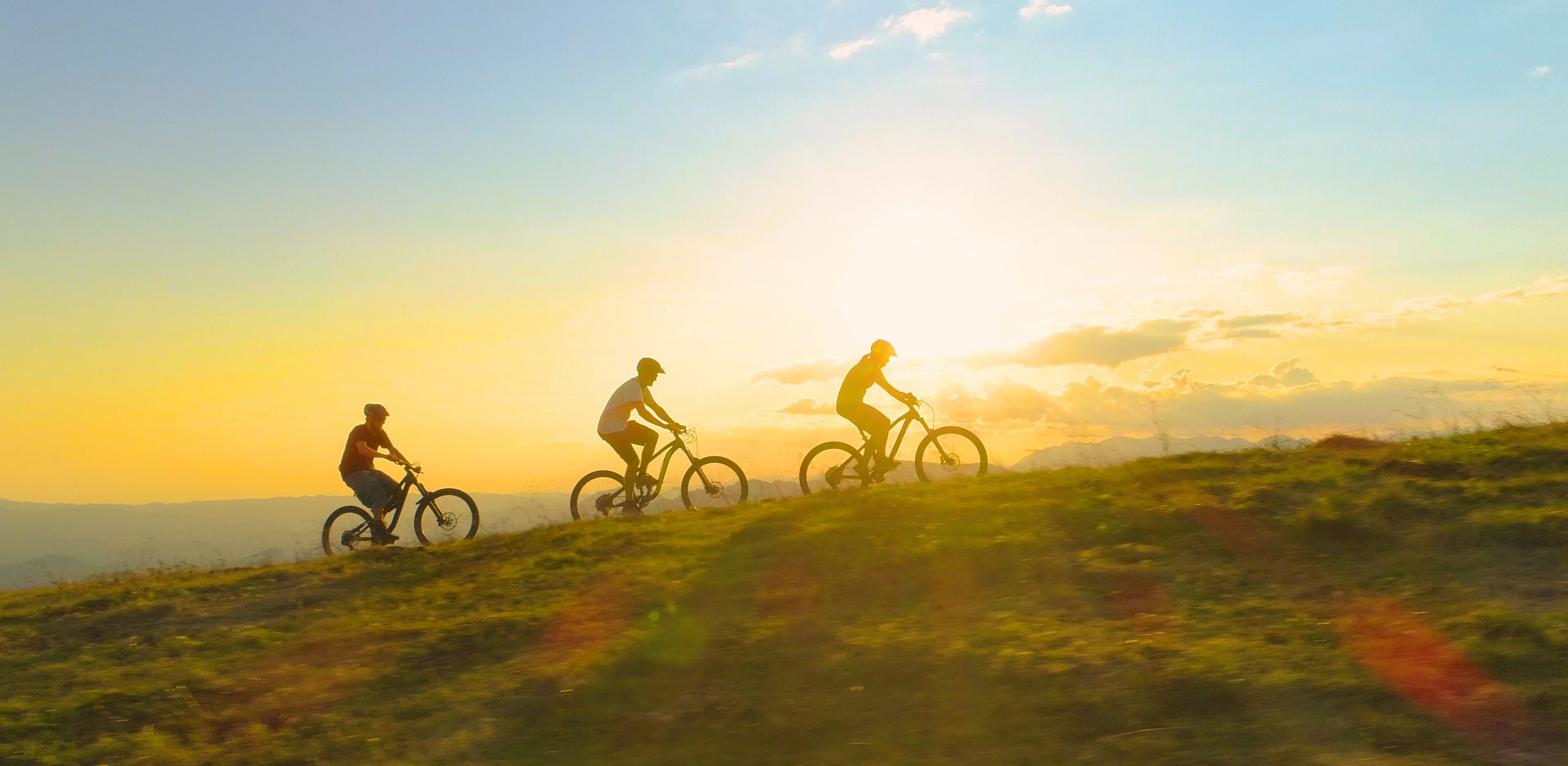 Cyclist pushing hard on a hill climb